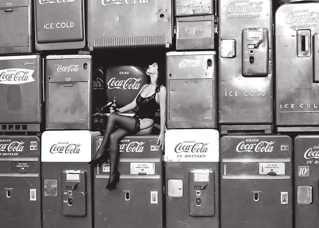 Vintage Allure: A Sultry Encounter Amidst Classic Coca-Cola Machines