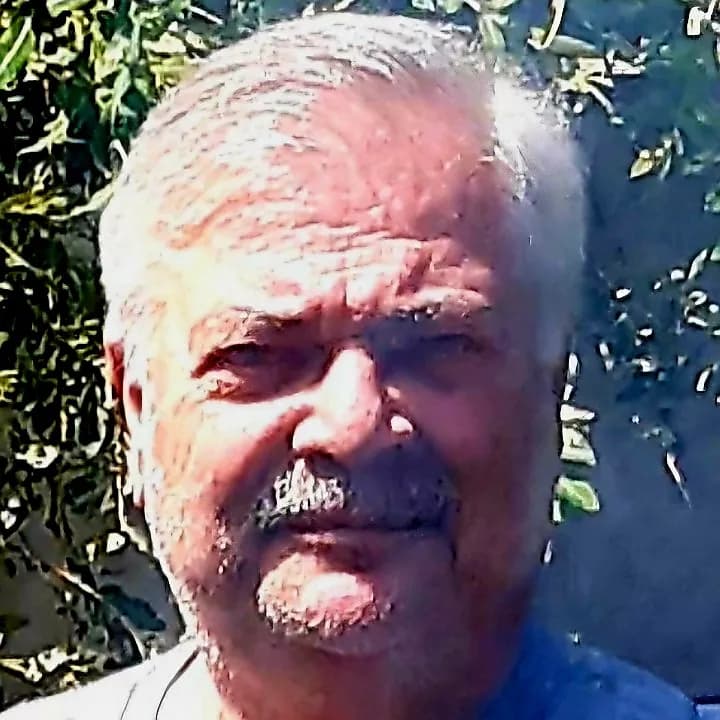 Portrait of Joy: A Mature Man Smiling in Nature's Embrace