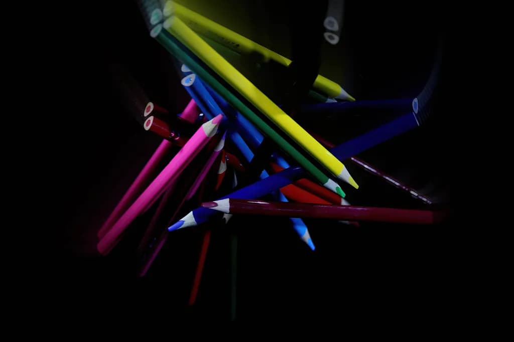Vibrant Chaos: A Dance of Colorful Pencils in the Dark