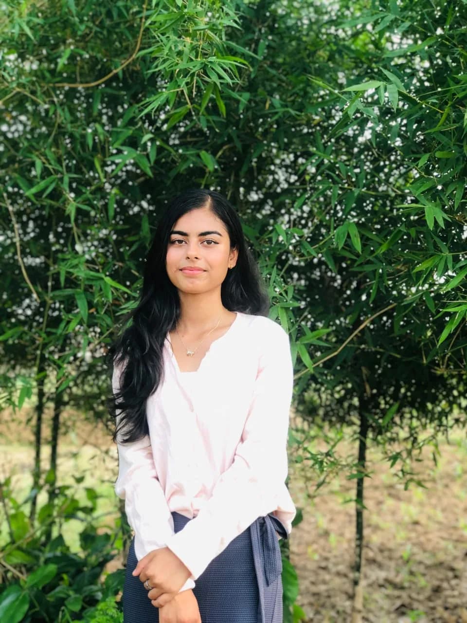 Serenity in Nature: A Portrait of Youthful Joy Amidst Greenery