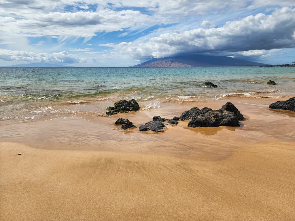 Serenity by the Shore: A Tranquil Beachscape with Rocks and Gentle Waves