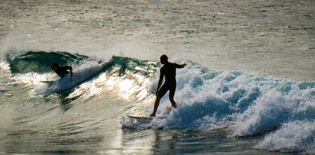 Sunset Surfing: Embracing the Ocean's Dance of Waves and Action