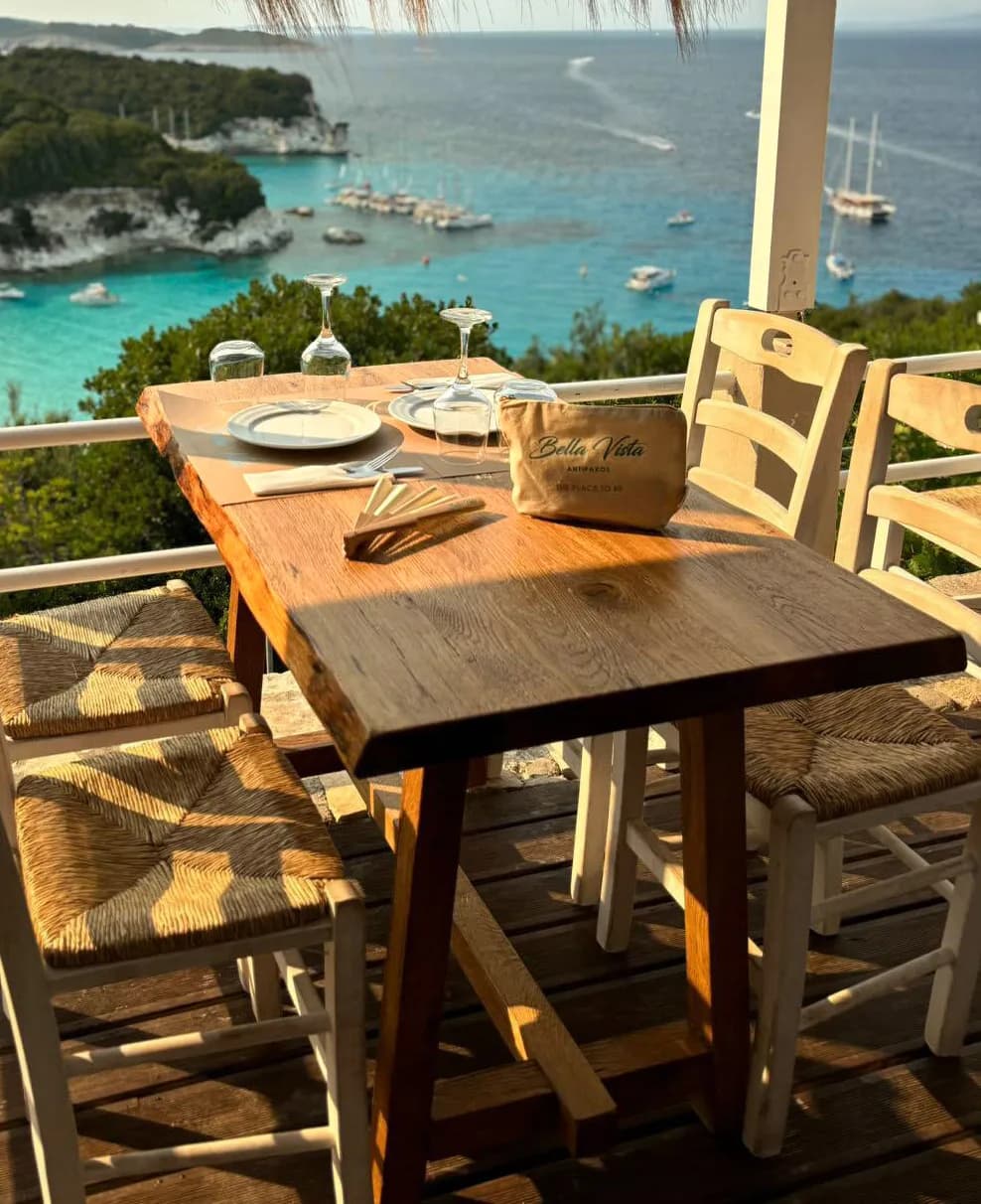 Serene Seaside Dining: A Table with a View of Tranquil Waters and Coastal Charm