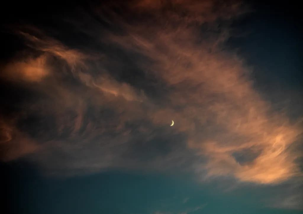 Whispers of Twilight: A Celestial Dance of Clouds and Moonlight