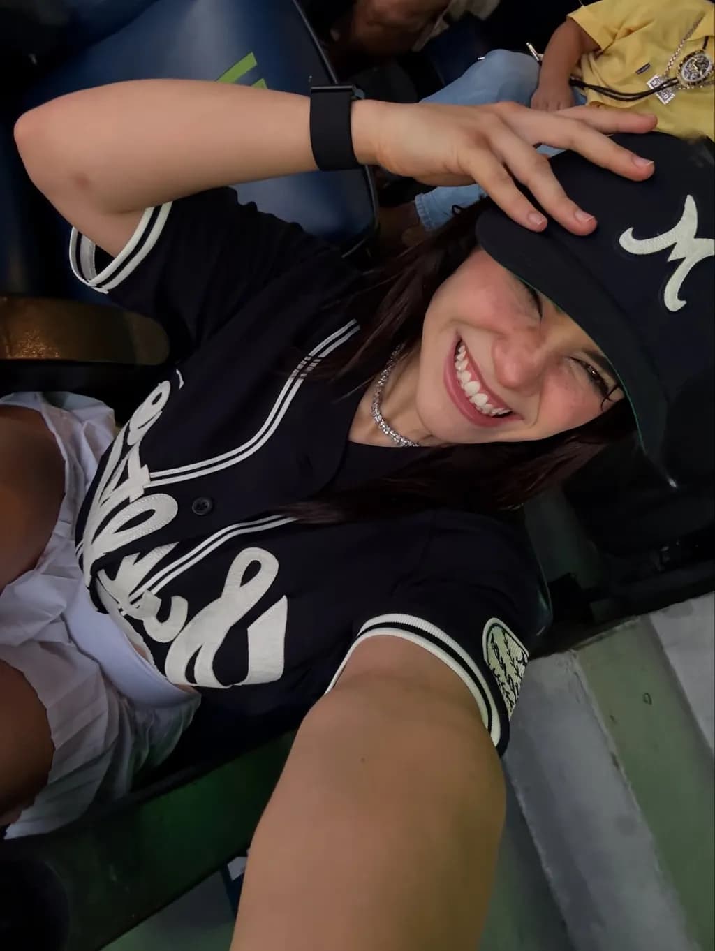Joyful Moments in the Stands: A Playful Selfie at the Game
