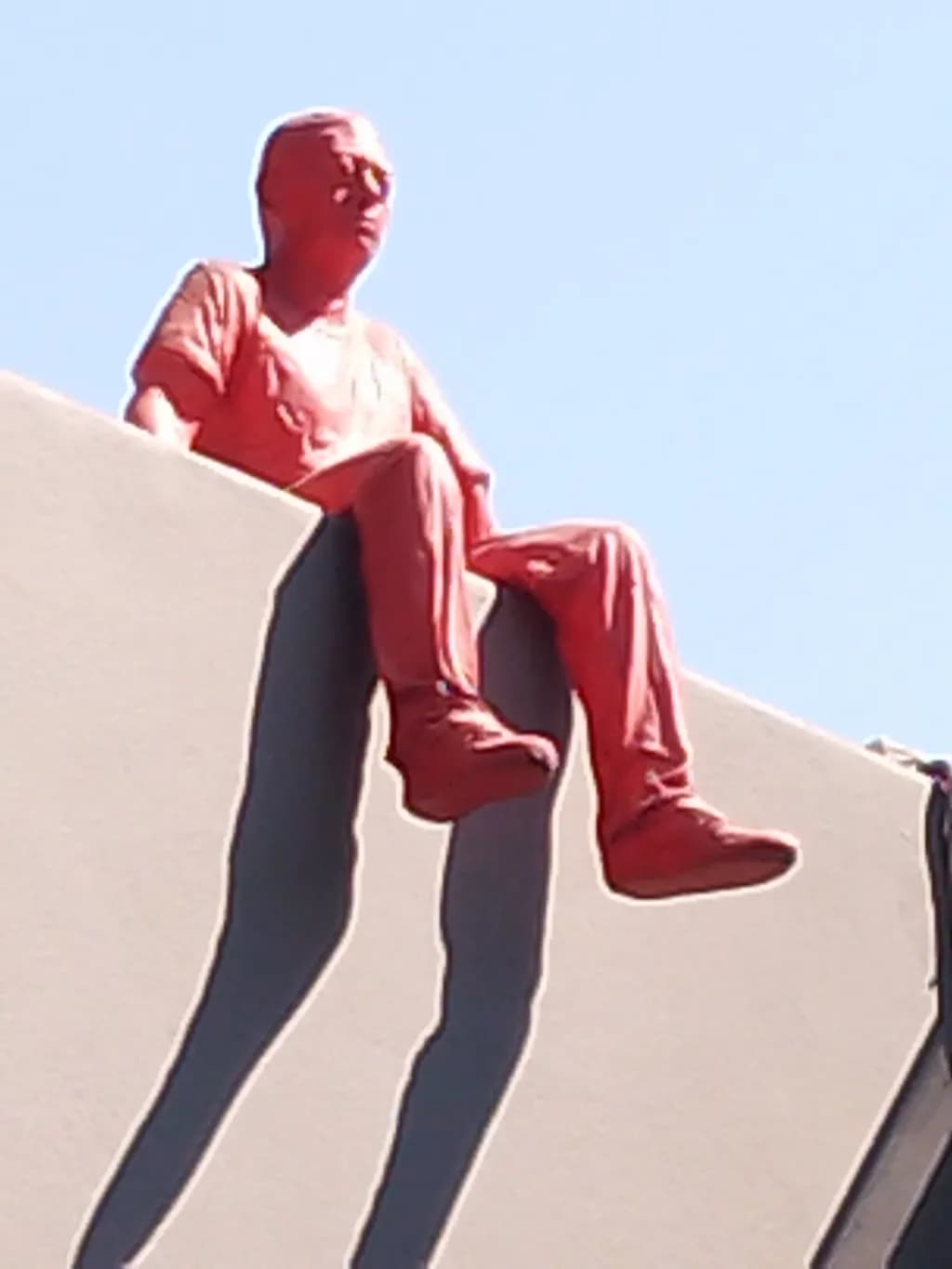 Contemplative Shadow: A Contemporary Orange Sculpture of Solitude