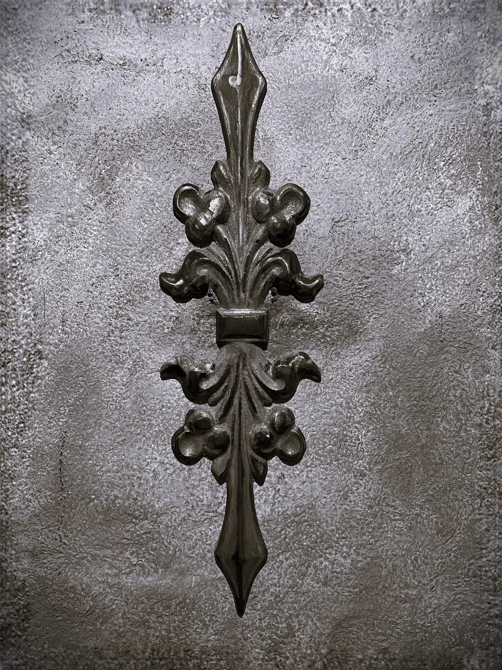 Elegant Iron Flourish on Textured Gray Canvas