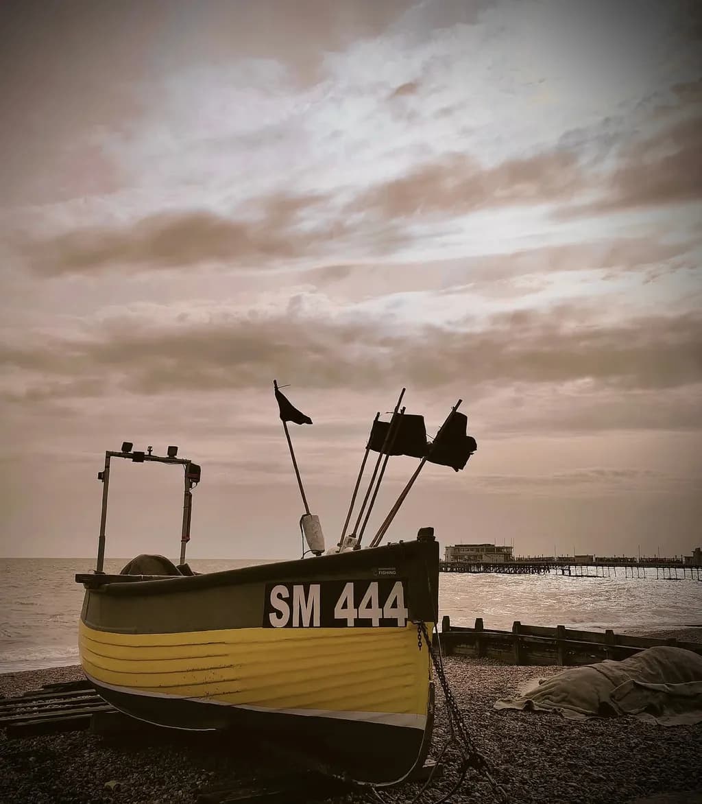Serenity at the Shore: A Nostalgic Coastal Scene with the Yellow Boat SM 444