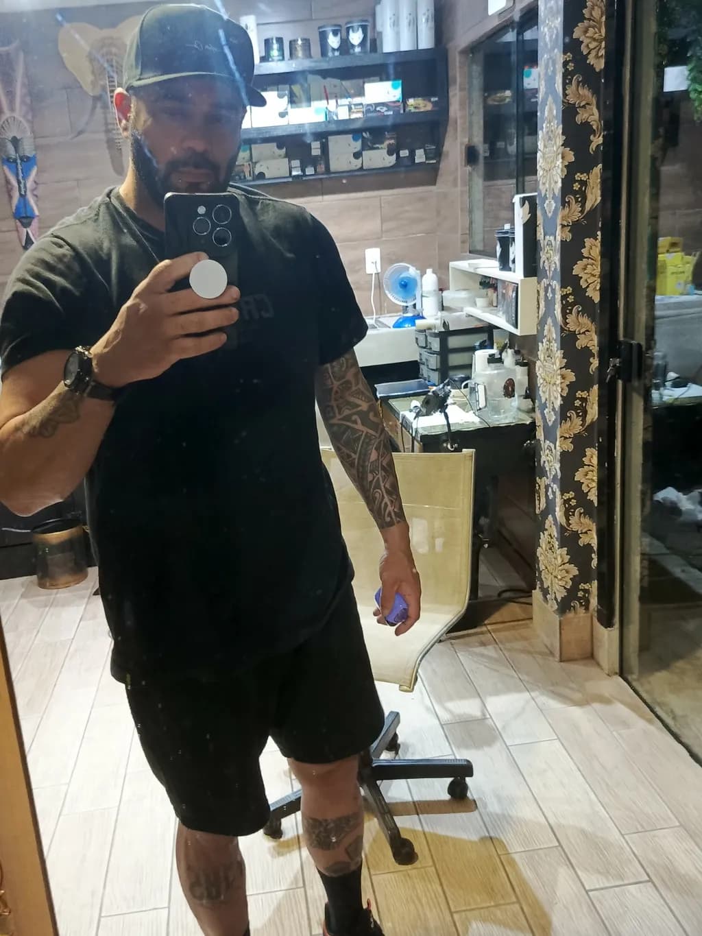 Reflections of Ink: A Tattoo Artist's Self-Portrait in the Studio