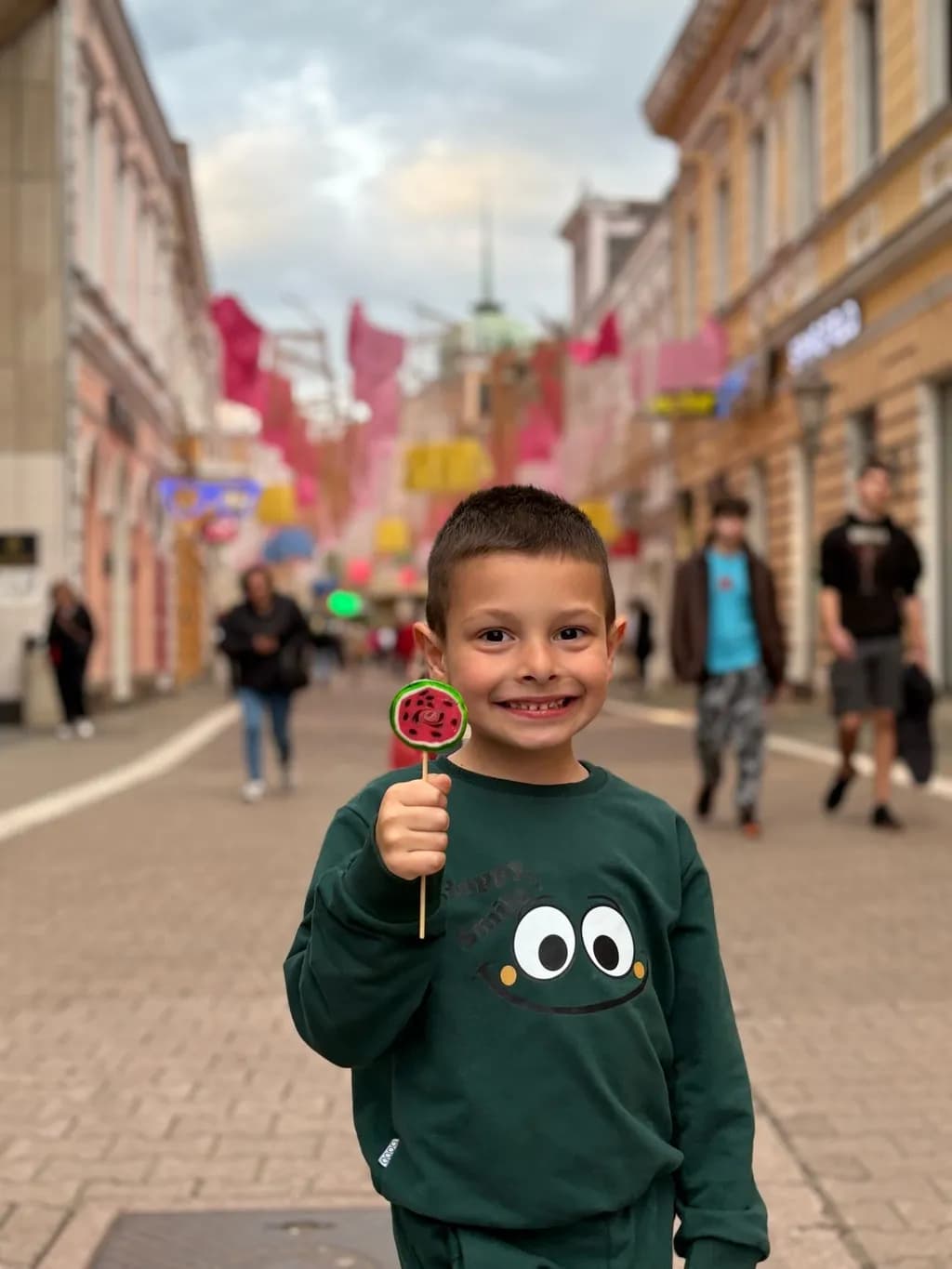 Joyful Moments: A Playful Child with a Lollipop in a Colorful Street Scene