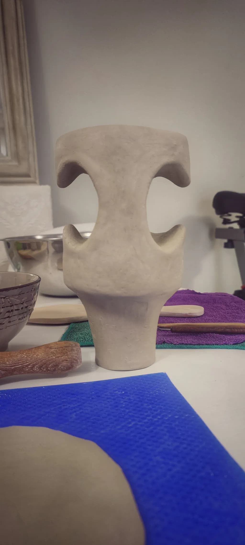 Sculptural Elegance: A Contemporary Clay Vase in the Artisan's Workspace