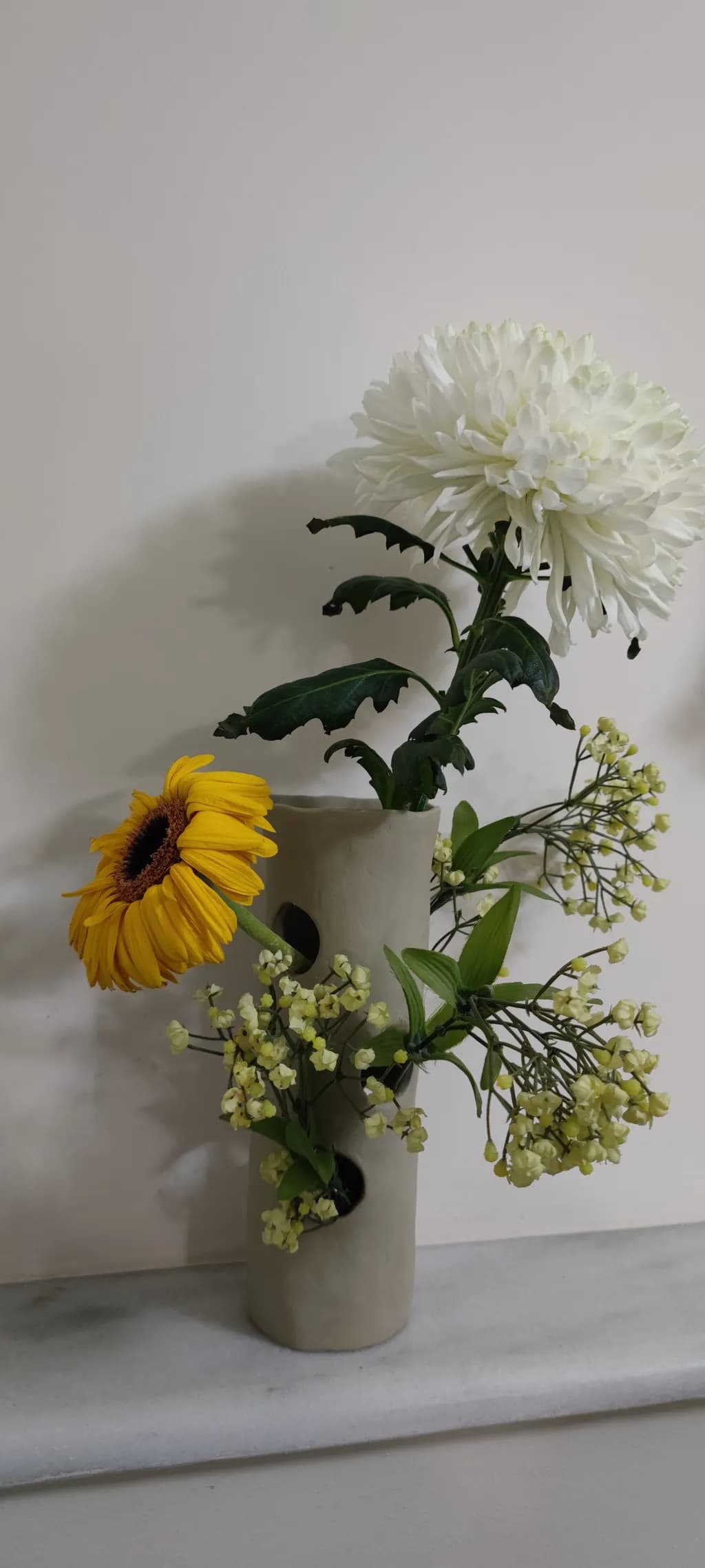 Sunlit Serenity: A Vibrant Floral Arrangement in a Modern Vase