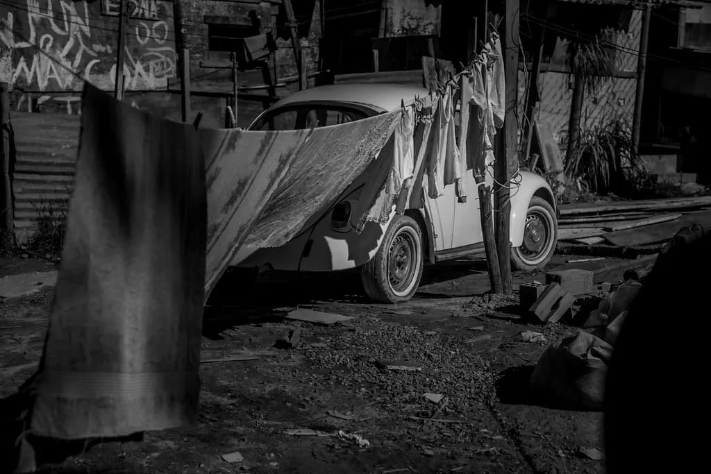 Whispers of Time: A Vintage Car Amidst the Laundry Lines in Monochrome Serenity