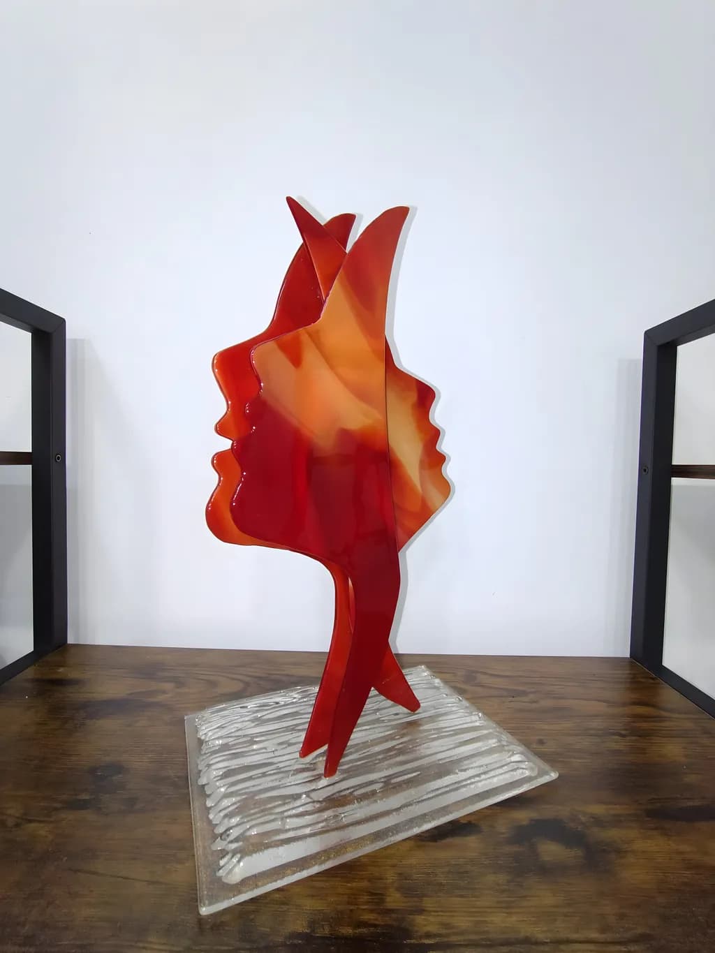 Whispers of Connection: A Dual-Faced Sculpture in Fiery Hues