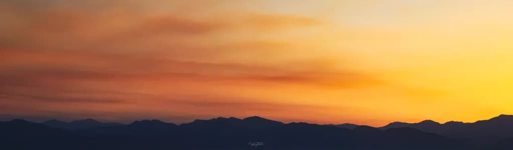 Whispers of Dusk: A Serene Mountain Sunset Embrace