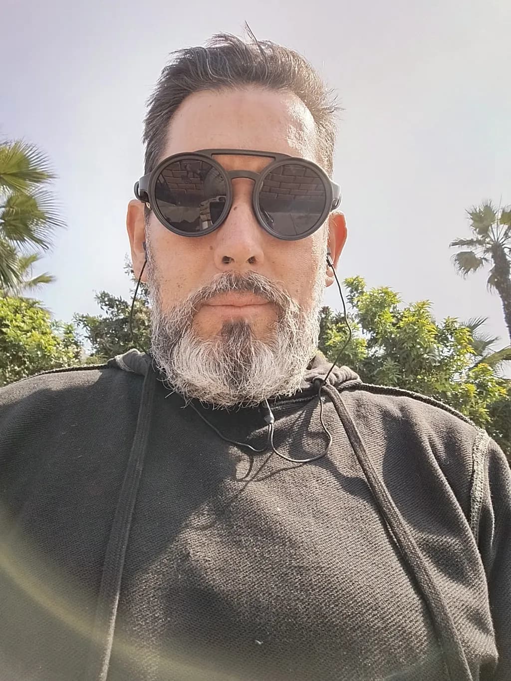Urban Chill: A Relaxed Portrait of Modern Masculinity in Sunglasses and Hoodie