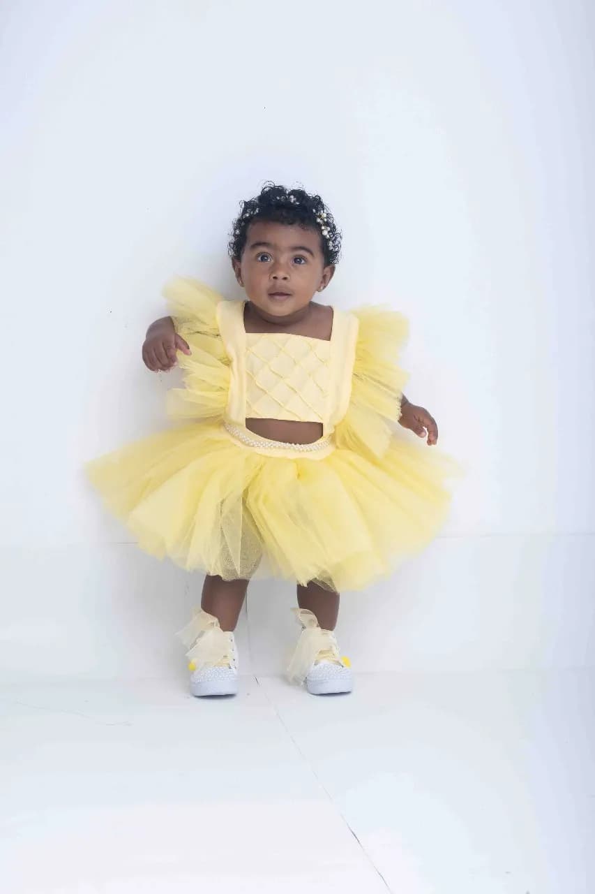 Whimsical Sunshine: A Playful Portrait of Childhood in Yellow Tulle