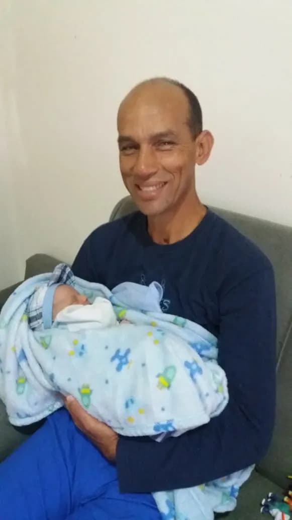 Tender Moments: A Father's Embrace with His Newborn Child