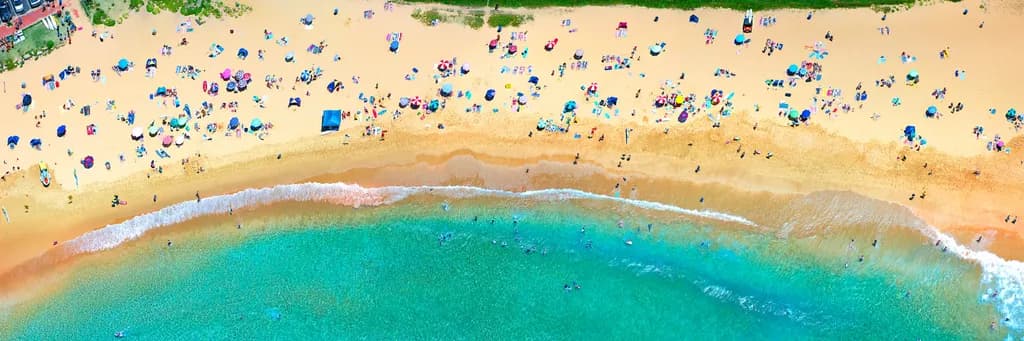 Vibrant Coastal Serenity: Aerial View of Sun-Kissed Beach Life