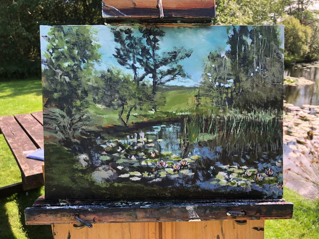 Serenity in Nature: A Tranquil Pond Scene with Lush Greenery and Water Lilies