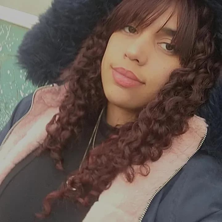 Curly Confidence: A Portrait of Casual Elegance in a Cozy Hoodie