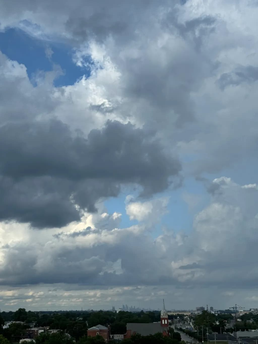 Whispers of Light: A Dramatic Sky Over Urban Horizons