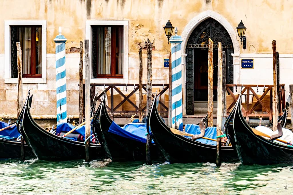 Venetian Serenity: Gondolas at the Foscari Palace, Embracing Timeless Elegance on the Canals