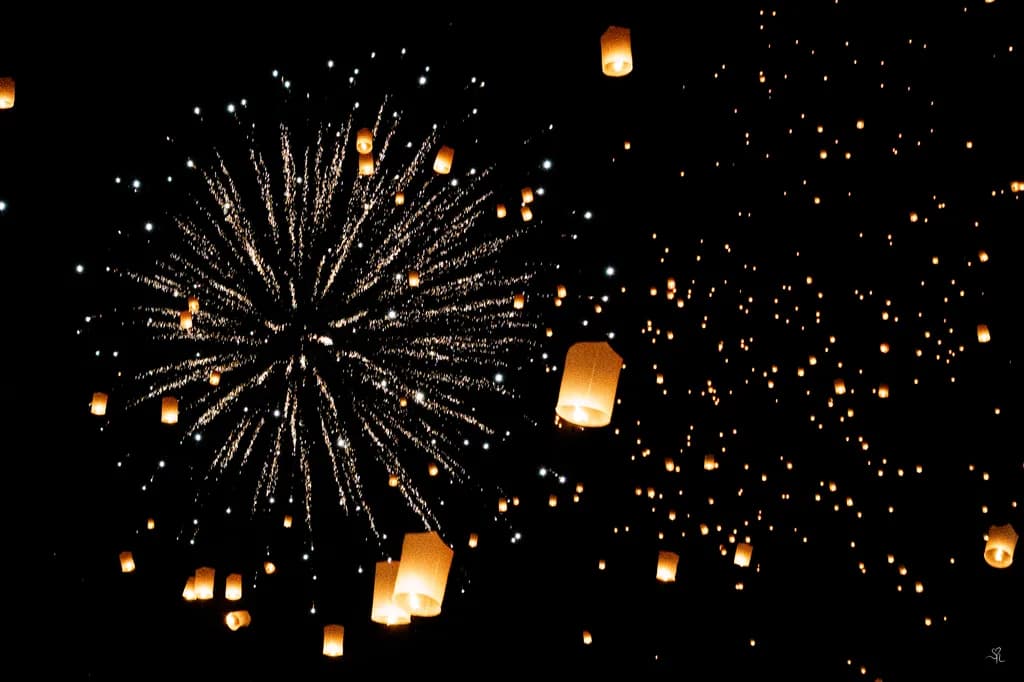 Celestial Celebration: Lanterns and Fireworks Illuminate the Night Sky