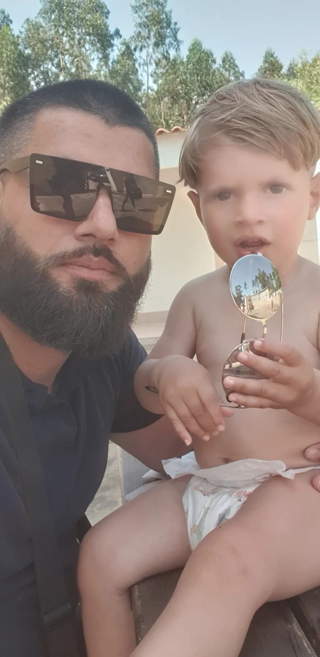 Sunshine Moments: A Father and Son's Playful Bond in Shades