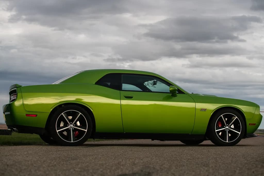 Vibrant Green Dreams: A Sporty Performance Car Under Cloudy Skies