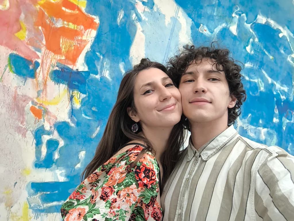 Vibrant Connections: A Colorful Embrace Against an Artistic Backdrop