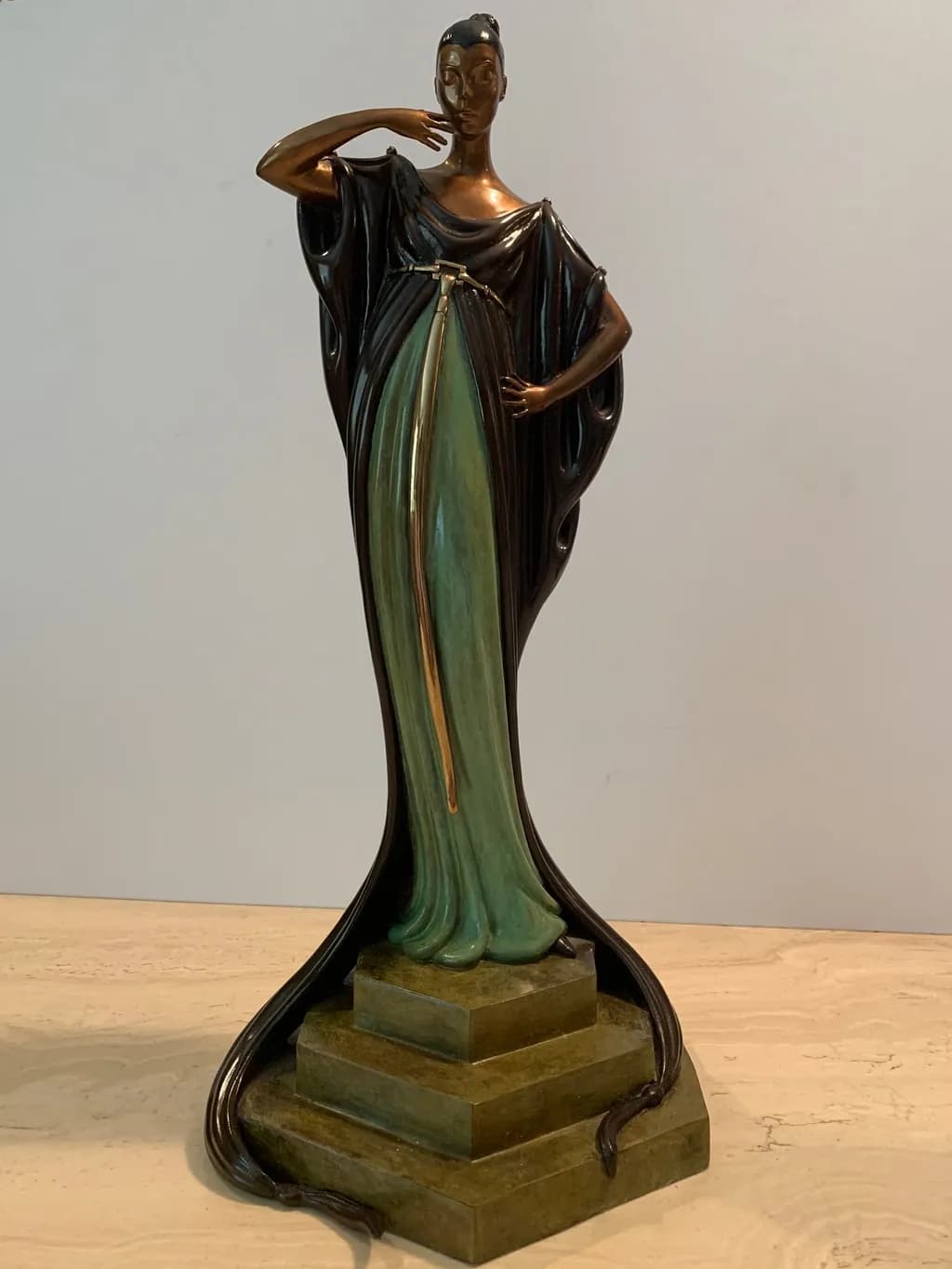 Elegant Serenity: A Graceful Bronze and Green Figurine on a Stately Base