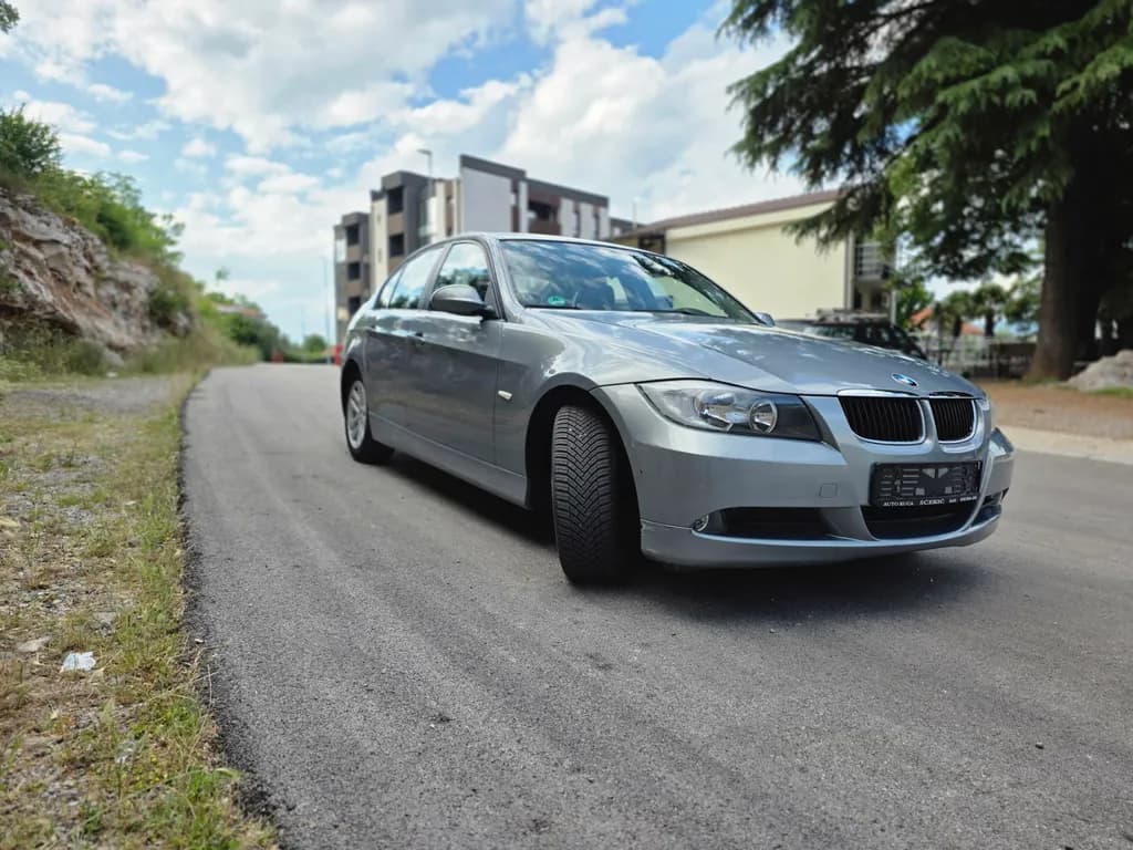 Urban Serenity: A Silver BMW on a Quiet Gray Road