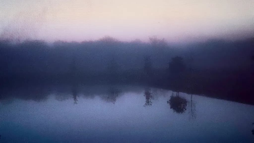 Whispers of Dawn: A Serene Reflection in Misty Waters