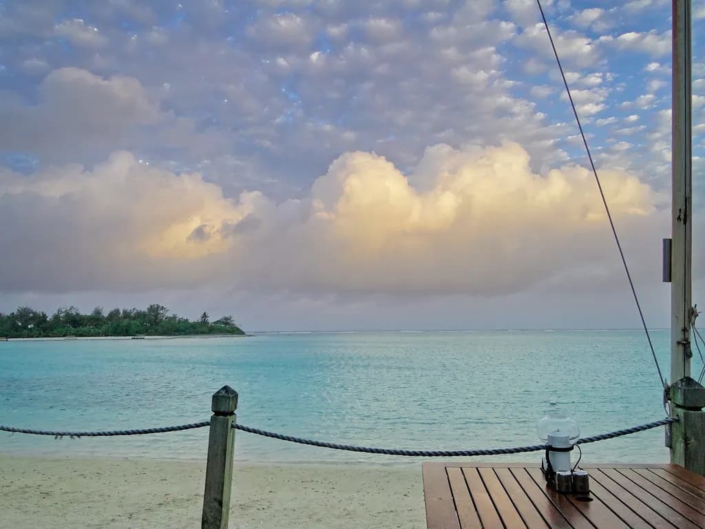 Serenity by the Shore: A Tranquil Beachscape Under Soft Clouds