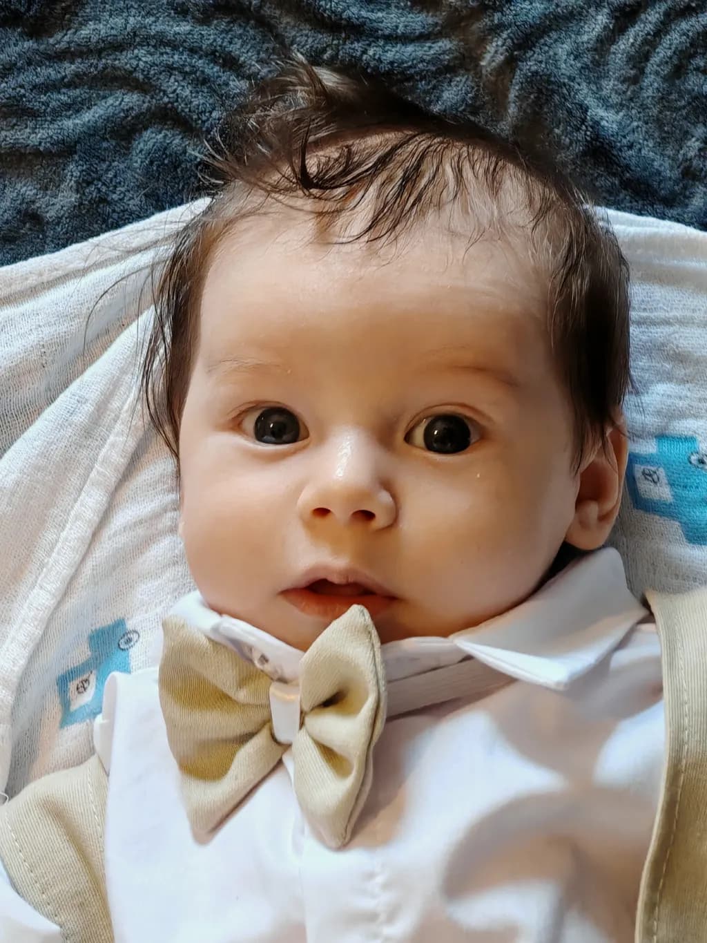 Adorable Innocence: A Curious Baby's Smile in Elegant Attire
