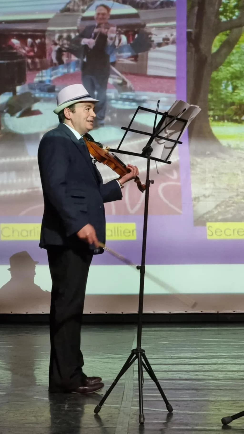 Melodic Moments: A Violinist's Stage Performance in a Hat
