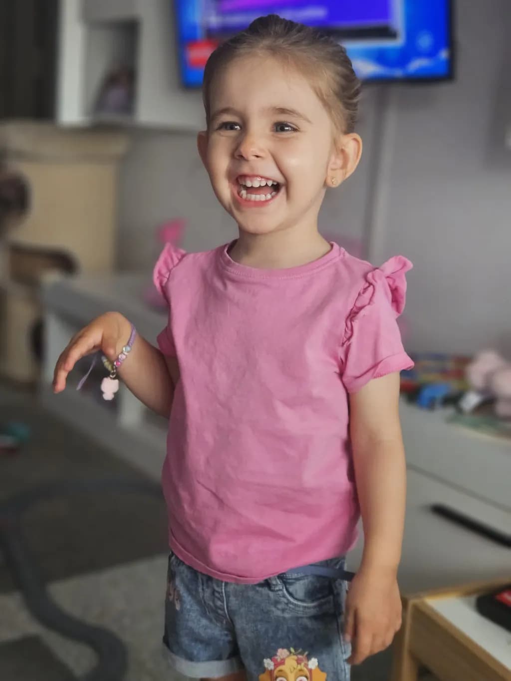 Joyful Innocence: A Radiant Smile in Pink and Denim