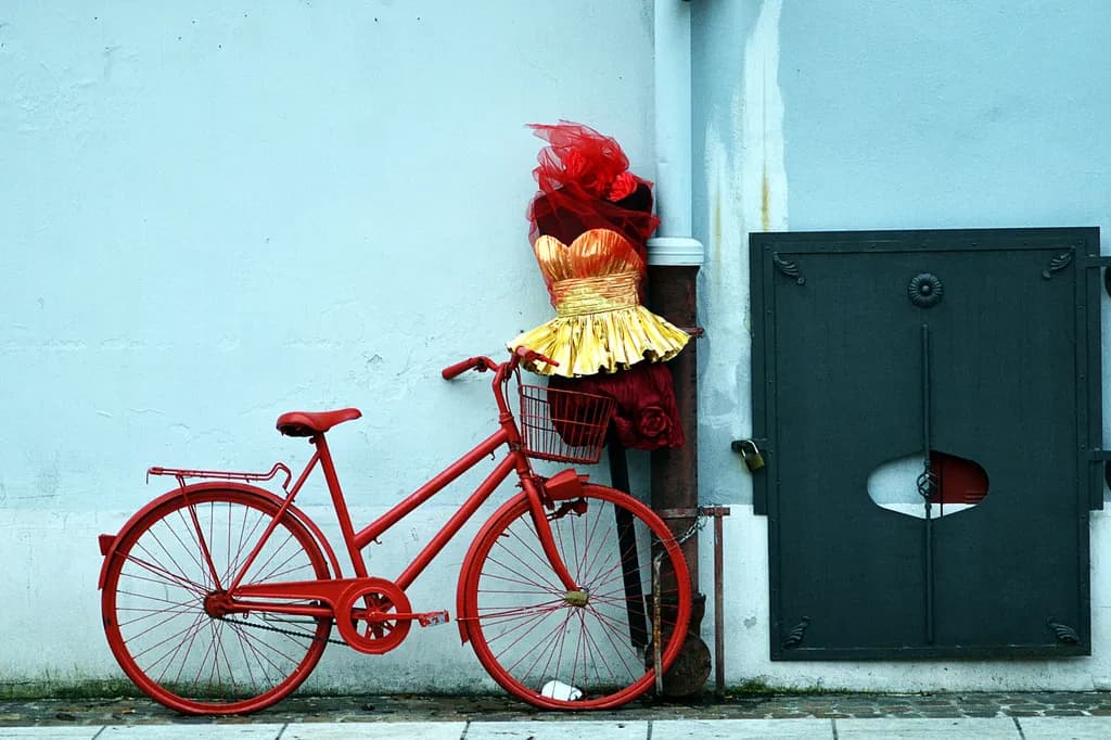 Whimsical Elegance: A Red Bicycle Adorned with Golden Glamour and Roses