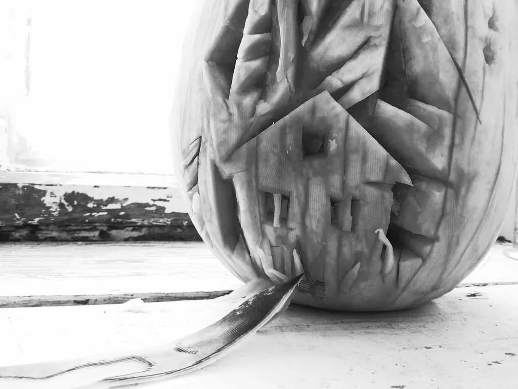 Whispers of Autumn: Intricate Pumpkin Carving of a Haunted House