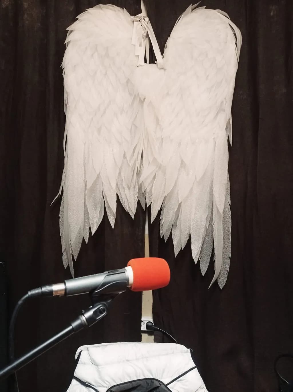 Whispers of Wings: Ethereal White Angel Wings Against a Dark Backdrop