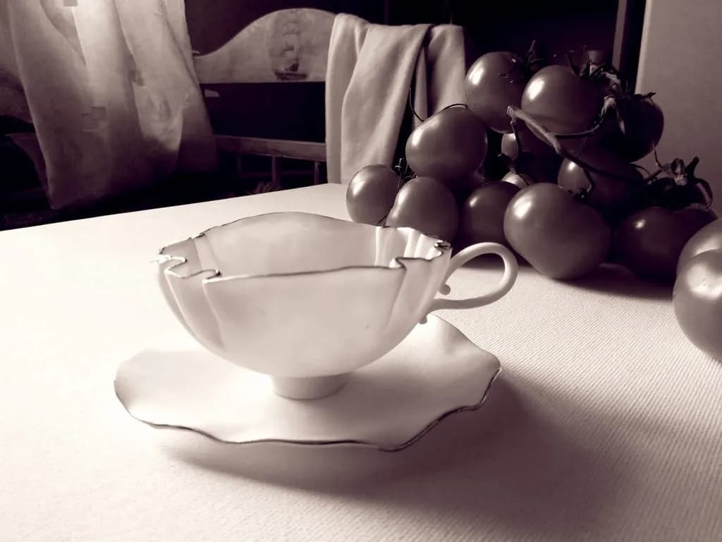 Whispers of Elegance: A Delicate Teacup Amidst Rustic Tomatoes