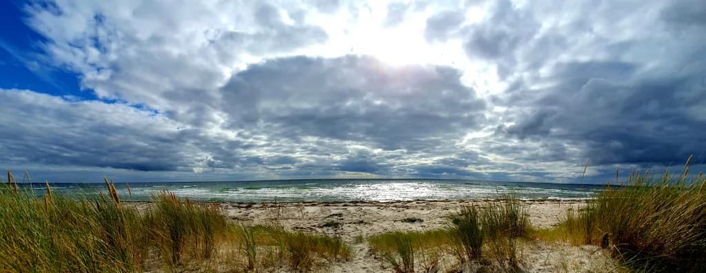 Serenity by the Shore: A Tranquil Beachscape Under Dramatic Skies