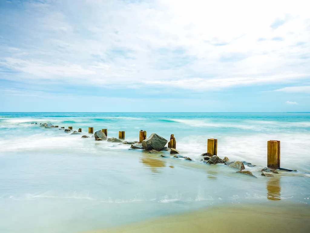 Serenity by the Shore: A Tranquil Journey Through Ocean Waves and Weathered Pilings
