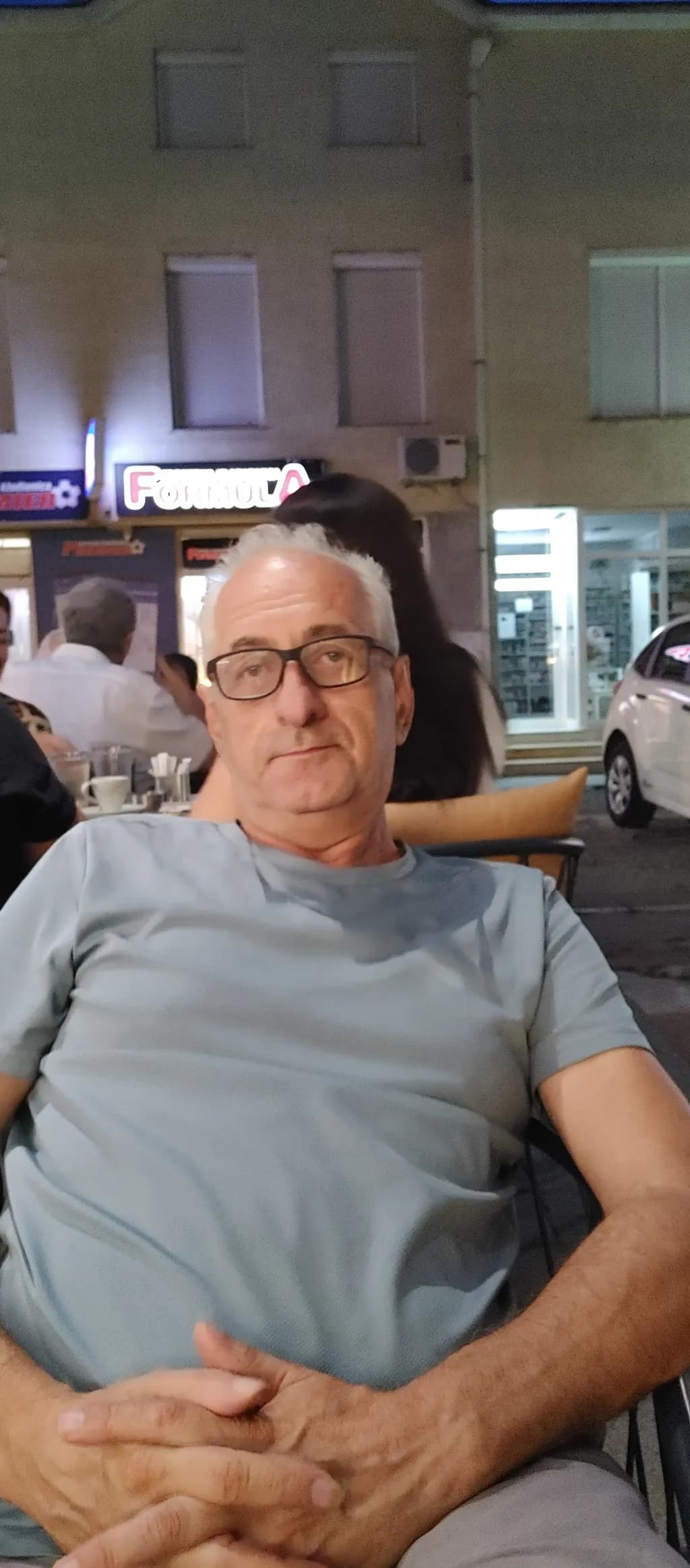 Evening Reflections: A Portrait of Contemplation in a Bustling Café
