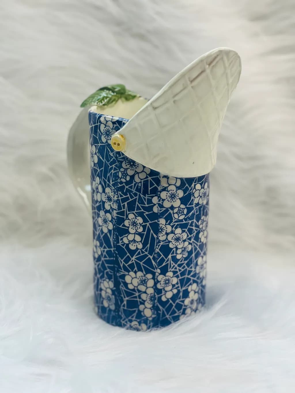 Whimsical Blue Floral Ceramic Pitcher with Unique Leaf Lid Design