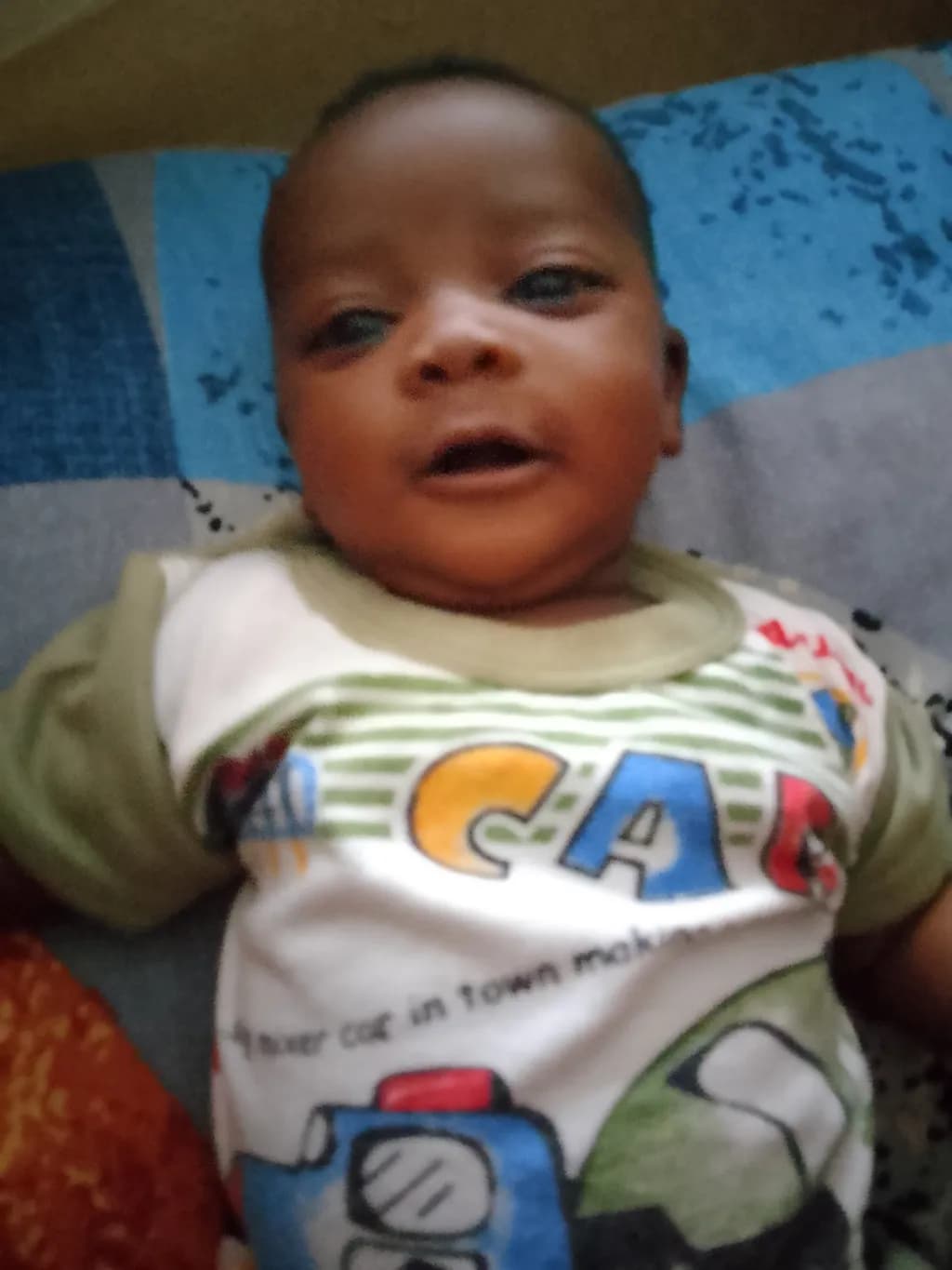 Joyful Innocence: A Playful Baby's Smile in Adorable Clothing