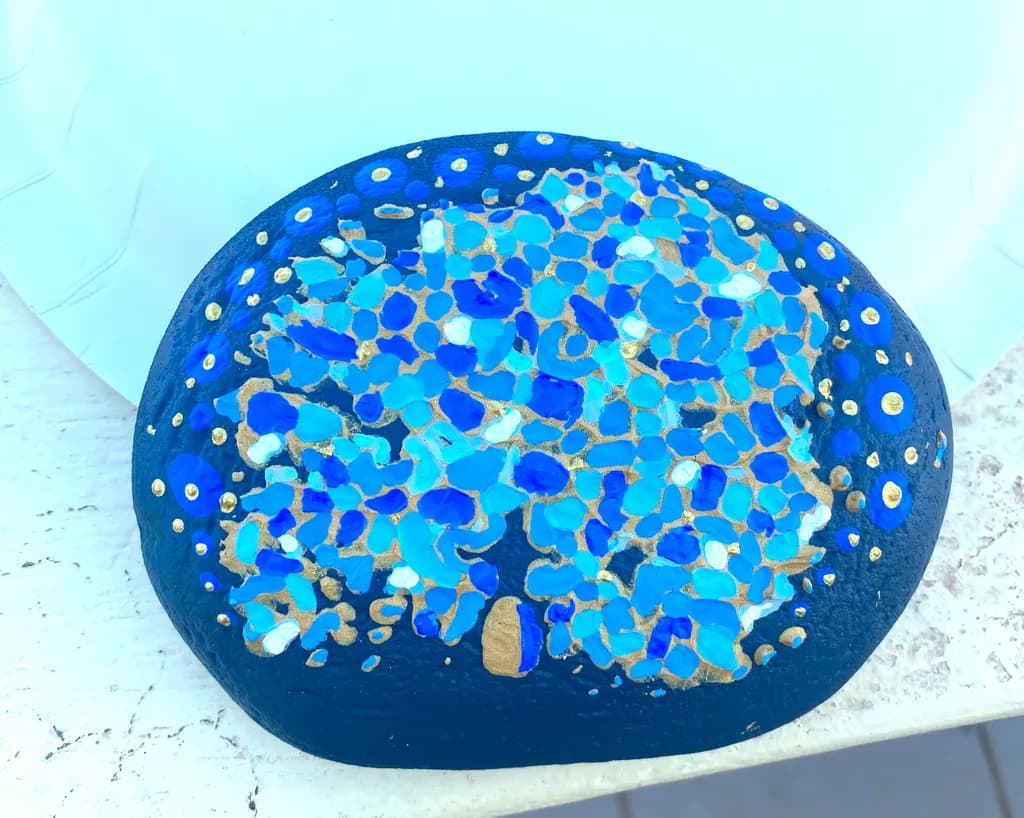 Oceanic Mosaic: A Hand-Painted Blue Stone with Golden Accents
