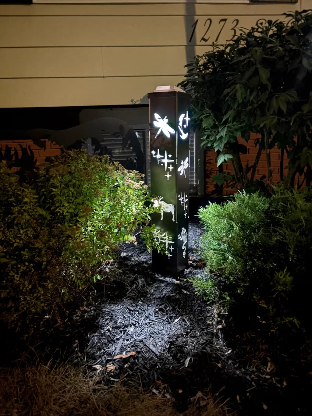 Illuminated Nature: A Sculptural Light Post Featuring Intricate Insect and Animal Designs