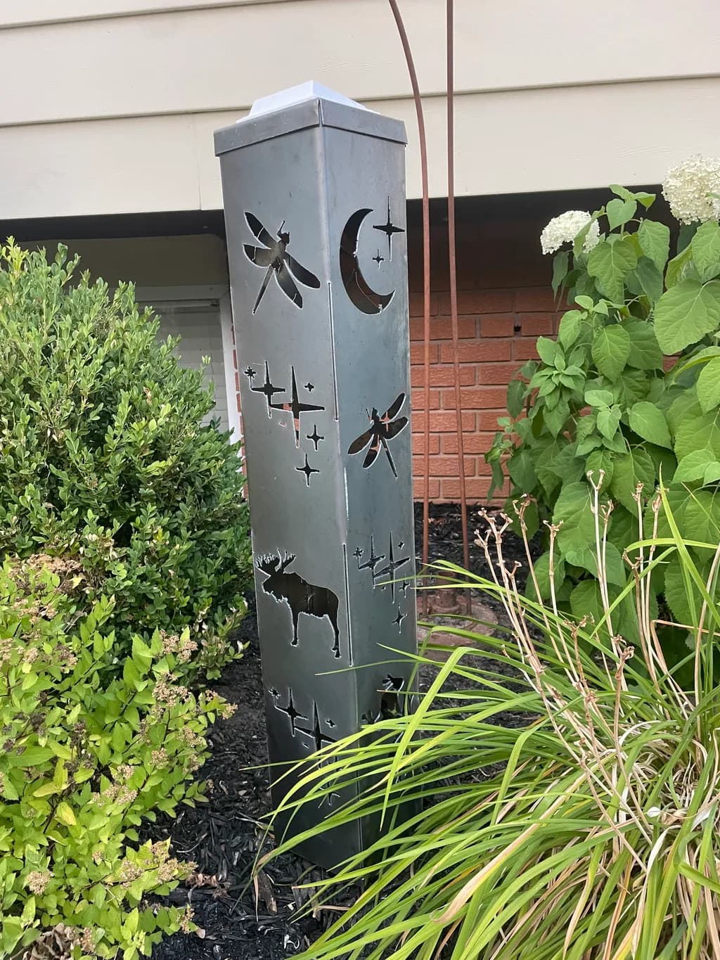 Nature's Silhouette: A Metal Sculpture of Wildlife and Celestial Wonders